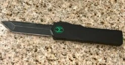 Heretic Knives Colossus T/E Blade Show '23 Black Slab Handle W/ Deep Engraved Heretic Green Logo Battle Black Blade