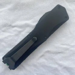 Heretic Knives Colossus T/E Blade Show '23 Black Slab Handle W/ Deep Engraved Heretic Green Logo Battle Black Blade -Helle Shop heretic knives heretic knives colossus t e blade show 23 black slab handle w deep engraved heretic green logo battle black blade 39393555284180